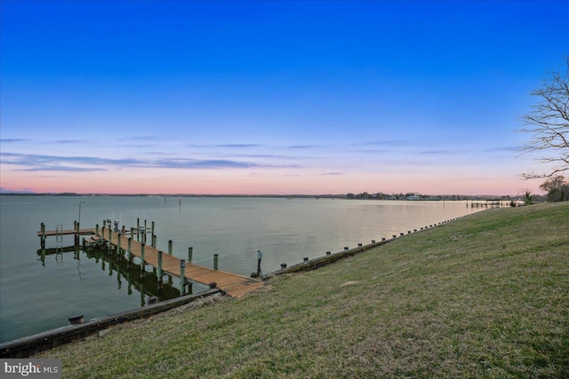 view of dock featuring a yard and a water view