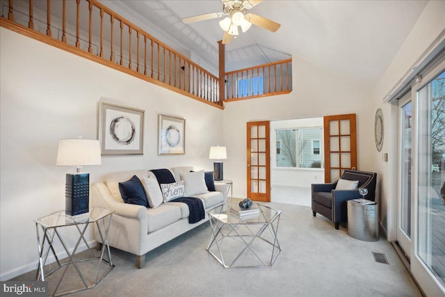 living area with visible vents, baseboards, carpet, ceiling fan, and french doors