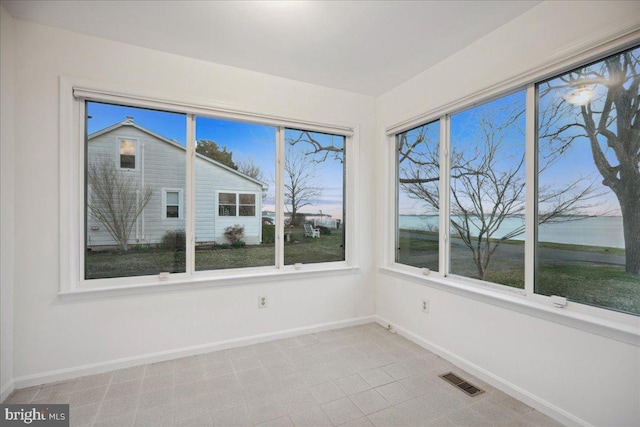 unfurnished sunroom with visible vents