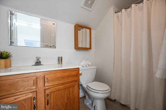 bathroom with visible vents, toilet, tile patterned flooring, lofted ceiling, and vanity