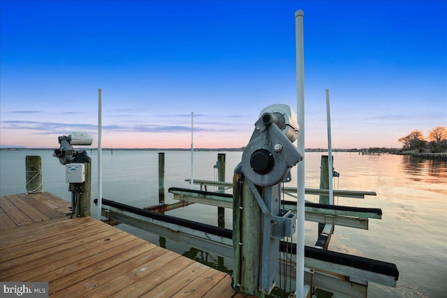 dock area with a water view and boat lift