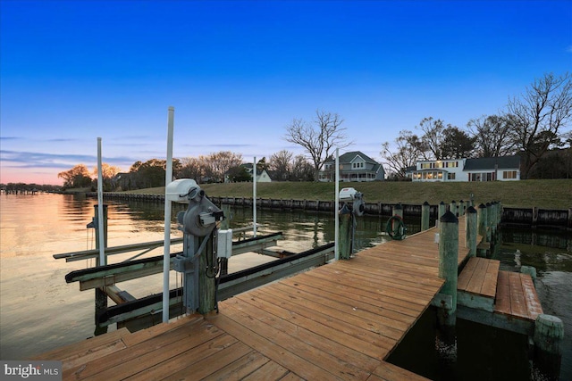 dock area with a water view and boat lift