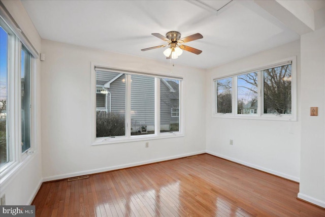 unfurnished room featuring hardwood / wood-style flooring, baseboards, and ceiling fan