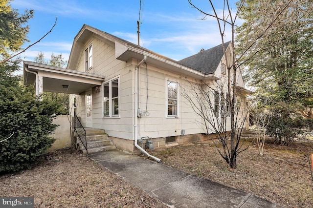 view of front of property featuring roof with shingles