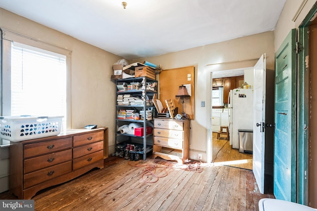 bedroom featuring freestanding refrigerator and hardwood / wood-style flooring