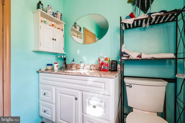 bathroom featuring toilet and vanity