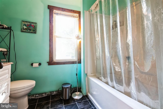 full bath featuring tile patterned flooring, toilet, and shower / bath combo with shower curtain