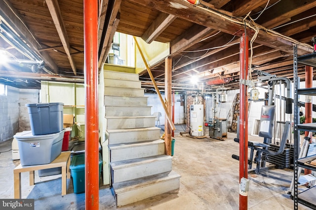 unfinished basement featuring water heater and stairs