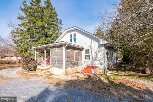 view of front of home featuring a sunroom