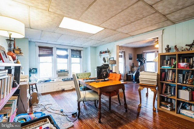 home office featuring a drop ceiling and hardwood / wood-style floors