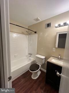 full bathroom featuring visible vents, tub / shower combination, toilet, wood finished floors, and vanity