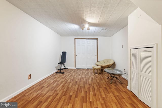 unfurnished room featuring baseboards and light wood finished floors