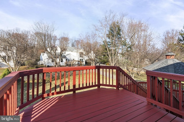 wooden deck featuring a gazebo and a residential view