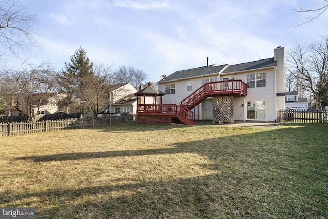 back of property featuring a fenced backyard, a gazebo, stairway, a wooden deck, and a chimney