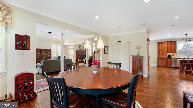 dining room featuring dark wood-type flooring, plenty of natural light, crown molding, and recessed lighting