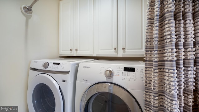 laundry room featuring cabinet space and washer and dryer