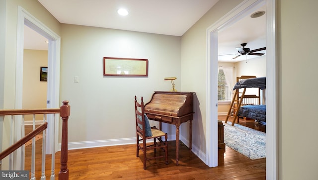 office space featuring ceiling fan, baseboards, wood finished floors, and recessed lighting