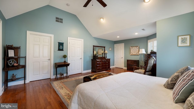 bedroom with visible vents, high vaulted ceiling, a ceiling fan, wood finished floors, and baseboards