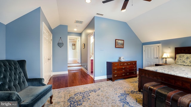 bedroom featuring a closet, visible vents, wood finished floors, and vaulted ceiling