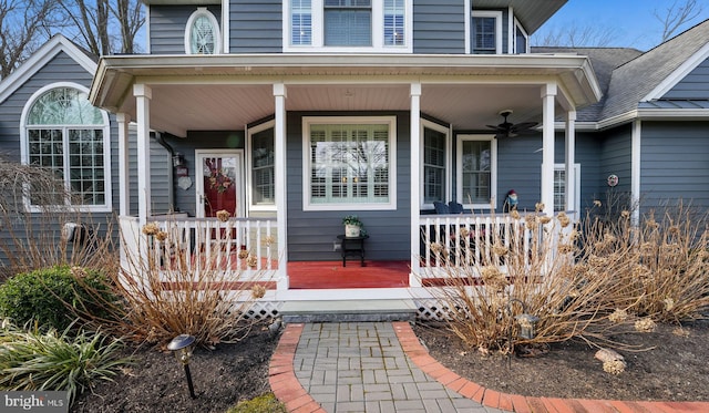 view of exterior entry featuring a porch and ceiling fan