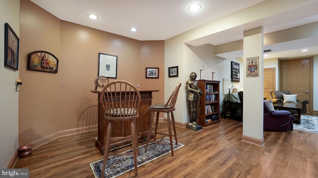 interior space featuring recessed lighting, baseboards, and wood finished floors