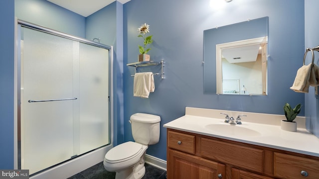 bathroom with visible vents, vanity, a shower stall, and toilet