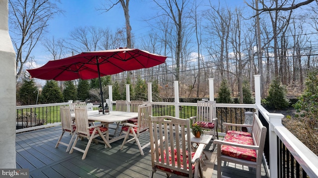 wooden deck featuring outdoor dining area