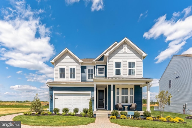 traditional home featuring a standing seam roof, an attached garage, covered porch, a front lawn, and metal roof