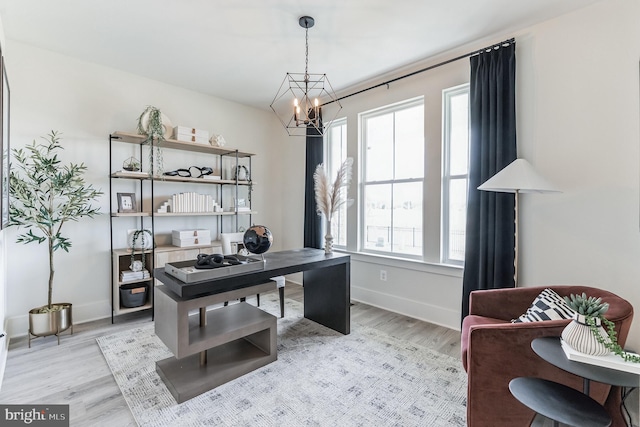 office area featuring a healthy amount of sunlight, baseboards, and light wood finished floors