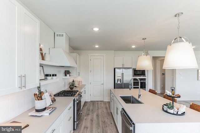 kitchen featuring white cabinets, open shelves, stainless steel appliances, and a sink