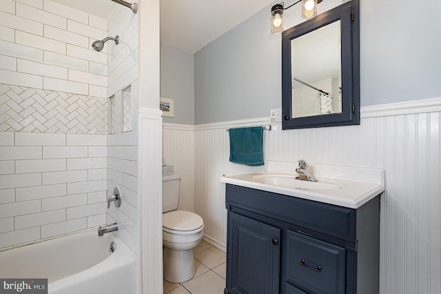 full bathroom featuring vanity, tile patterned floors, toilet, and a wainscoted wall