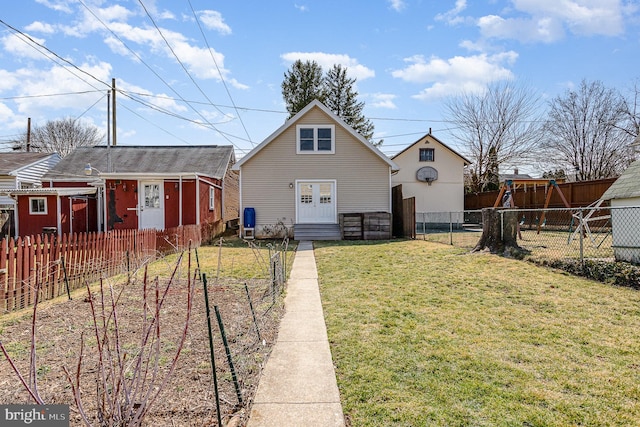 bungalow with entry steps, a front yard, a garden, and fence private yard