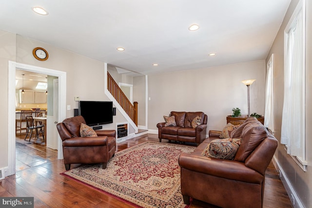 living area with recessed lighting, stairway, and hardwood / wood-style flooring