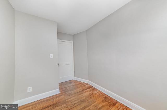 unfurnished room featuring light wood finished floors and baseboards