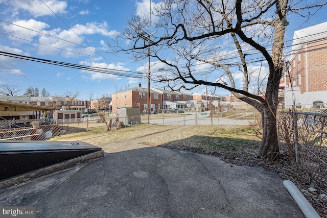 view of yard featuring fence and a residential view