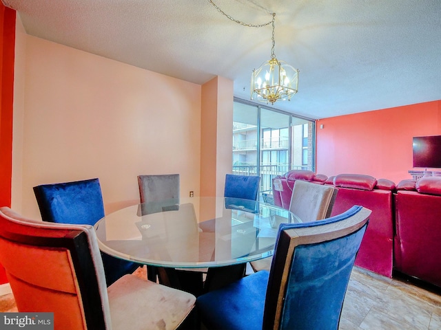 dining area with a notable chandelier and a textured ceiling