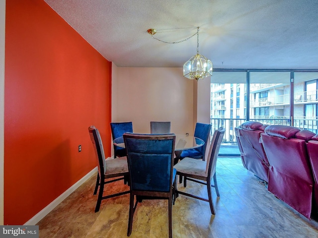 dining area with a wall of windows, baseboards, a notable chandelier, and a textured ceiling