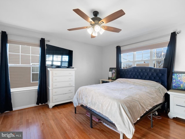 bedroom featuring a ceiling fan and wood finished floors