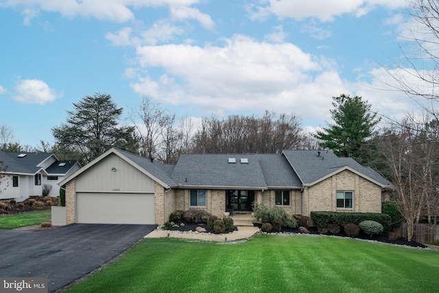 single story home featuring brick siding, a shingled roof, a front yard, a garage, and driveway