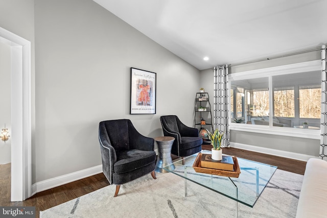 living area featuring recessed lighting, baseboards, lofted ceiling, and wood finished floors