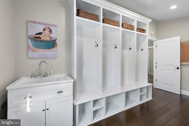 mudroom with a sink, recessed lighting, and dark wood-style flooring