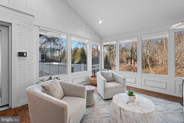 sunroom / solarium with a wealth of natural light and lofted ceiling