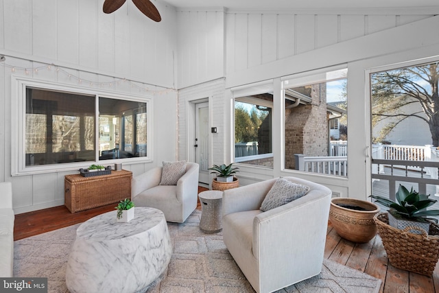 sunroom featuring ceiling fan and lofted ceiling