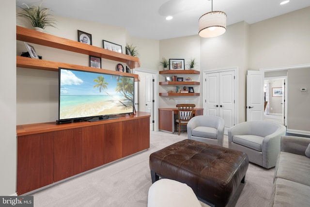 living area with recessed lighting and light colored carpet