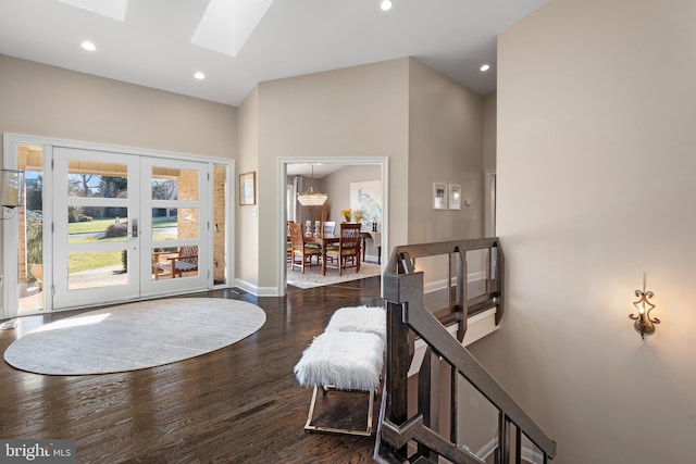 foyer with recessed lighting, french doors, a skylight, and dark wood-style flooring