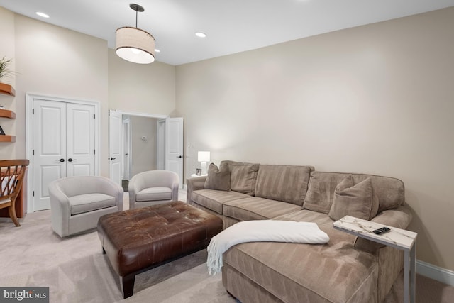 living room featuring recessed lighting, baseboards, and light carpet