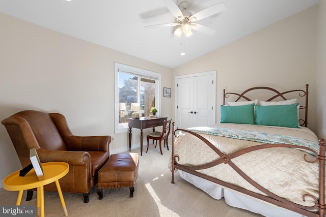 bedroom featuring a ceiling fan, baseboards, vaulted ceiling, a closet, and light colored carpet