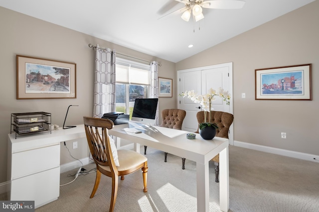 office area featuring baseboards, light colored carpet, a ceiling fan, and lofted ceiling