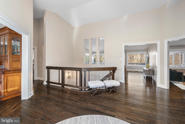 hallway featuring dark wood-style floors and baseboards