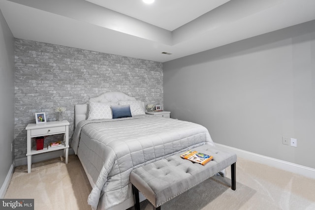 bedroom with visible vents, baseboards, and light carpet